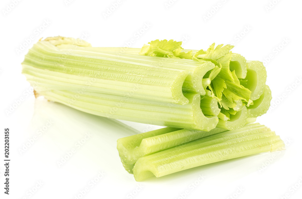 Fresh green celery and two sliced sticks isolated on white background. Fresh green celery and two sliced sticks isolated on white background.