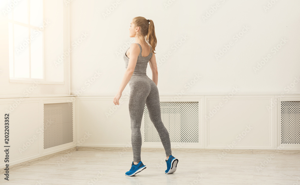 Beautiful fitness girl standing at gym Beautiful fitness girl standing at gym