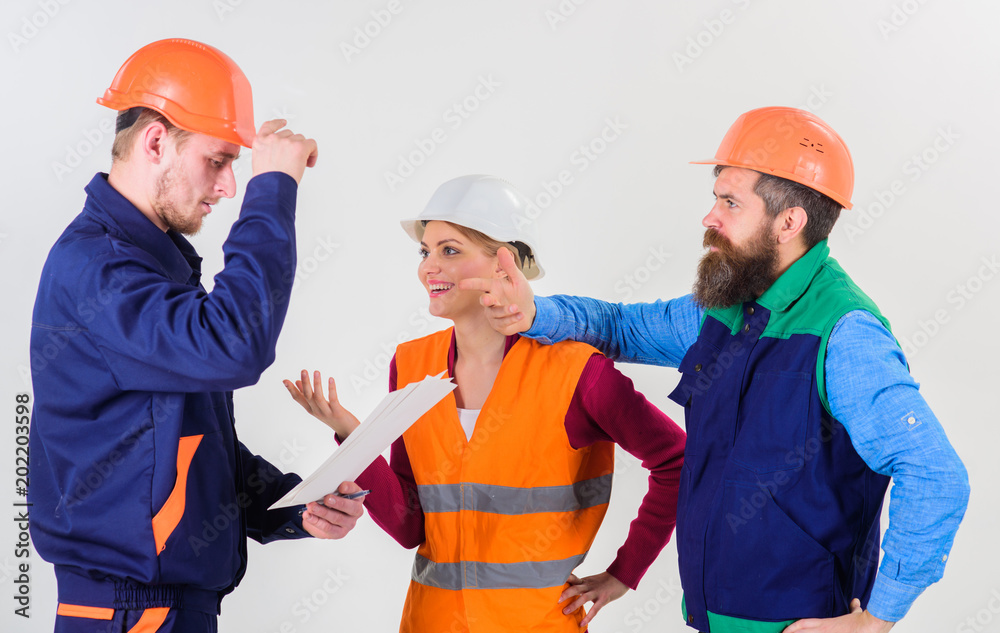 Team of architects, engineers discuss, looks at document Team of architects, engineers discuss, looks at document