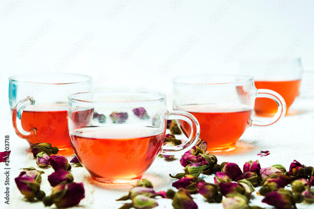 Rose tea and flower petals on white background Rose tea and flower petals on white background