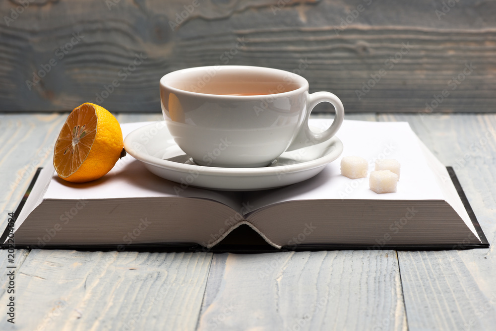 Obraz premium Tea cup on blank book pages making cozy composition