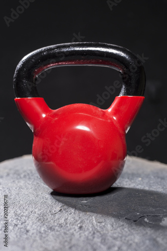 red kettlebells on roug surface