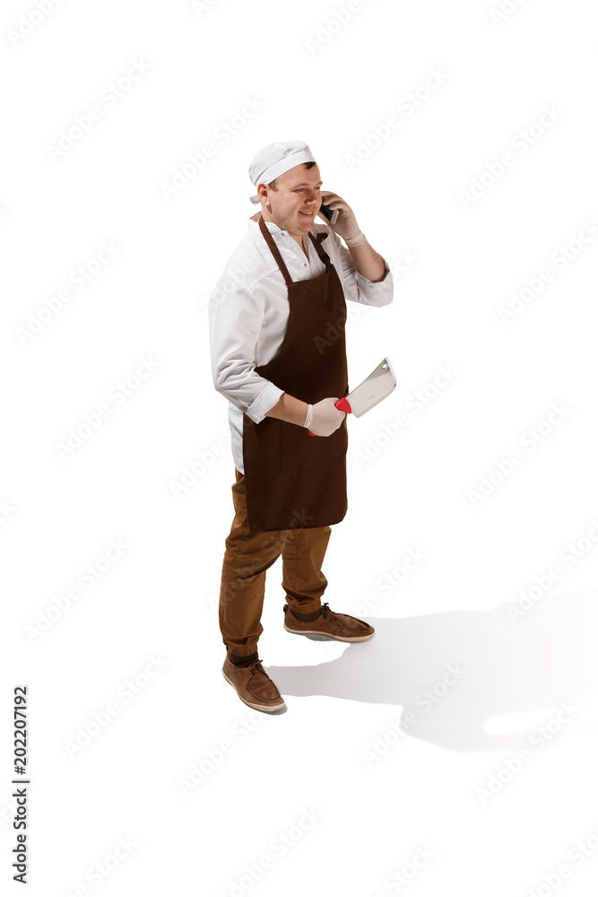 Smiling butcher posing with a cleaver isolated on white background Smiling butcher posing with a cleaver isolated on white background