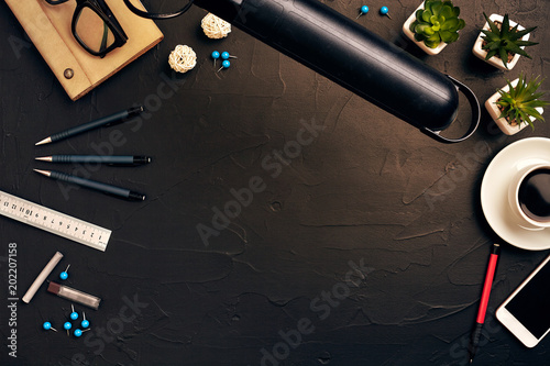 Engineer's desk in office with various gadgets and documents