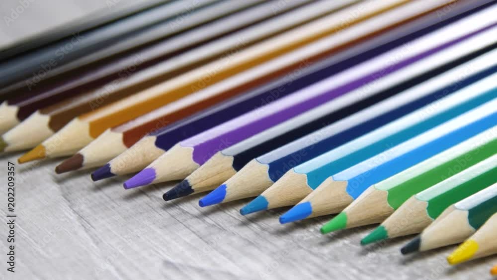 colored pencils lie on a gray background colored pencils lie on a gray background