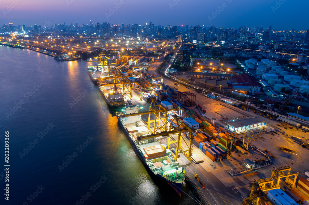 Containers yard in port congestion with ship vessels are loading and discharging operations of the transportation in international port.Shot from drone. - obrazy, fototapety, plakaty 