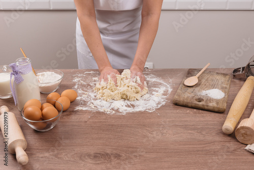 Hands working with dough preparation recipe bread.