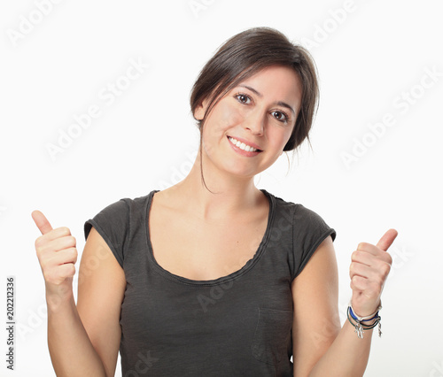 Brunette woman thumbs up isolated on white background photo