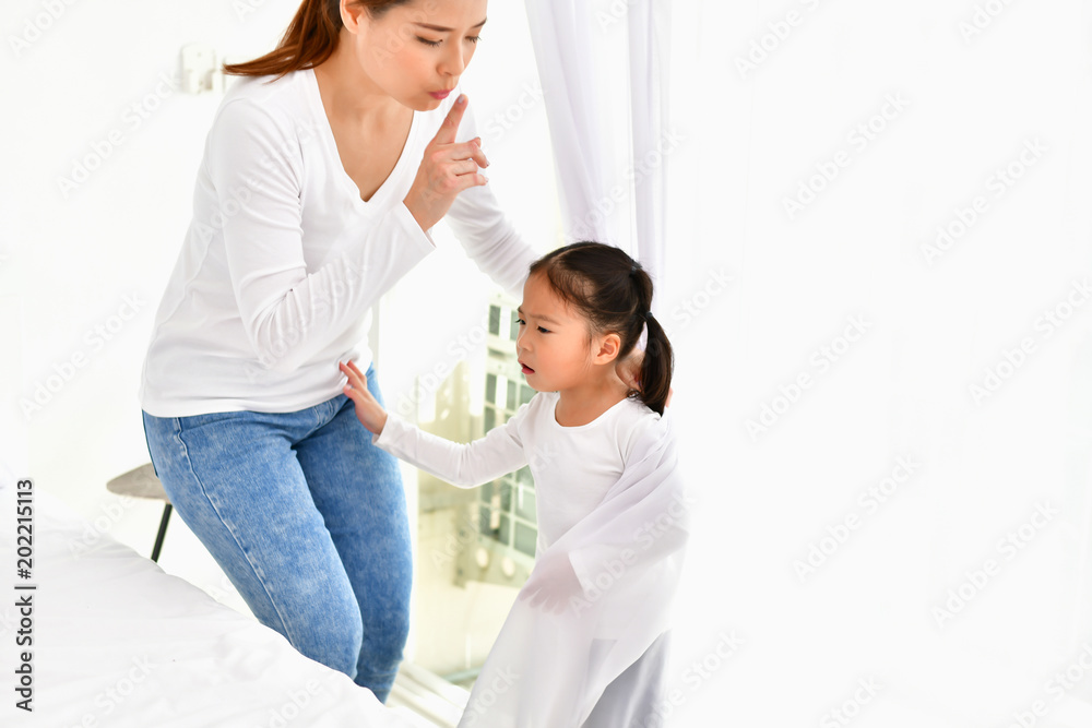 Mom is comforting her baby in the house. Mom is comforting her baby in the house.