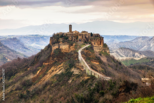 Civita di Bagnoregio, Viterbo, Lazio, Italy: picturesque landscape at dawn of the ancient village shrouded in fog on the steep tuff hill
