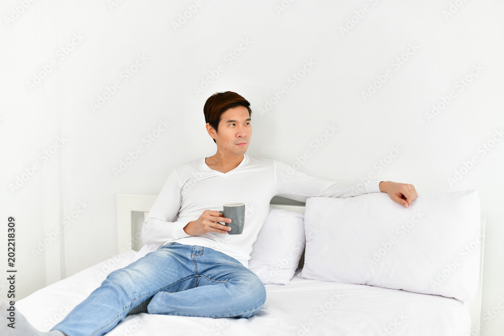 Men are playing mobile in the bedroom. Men are playing mobile in the bedroom.