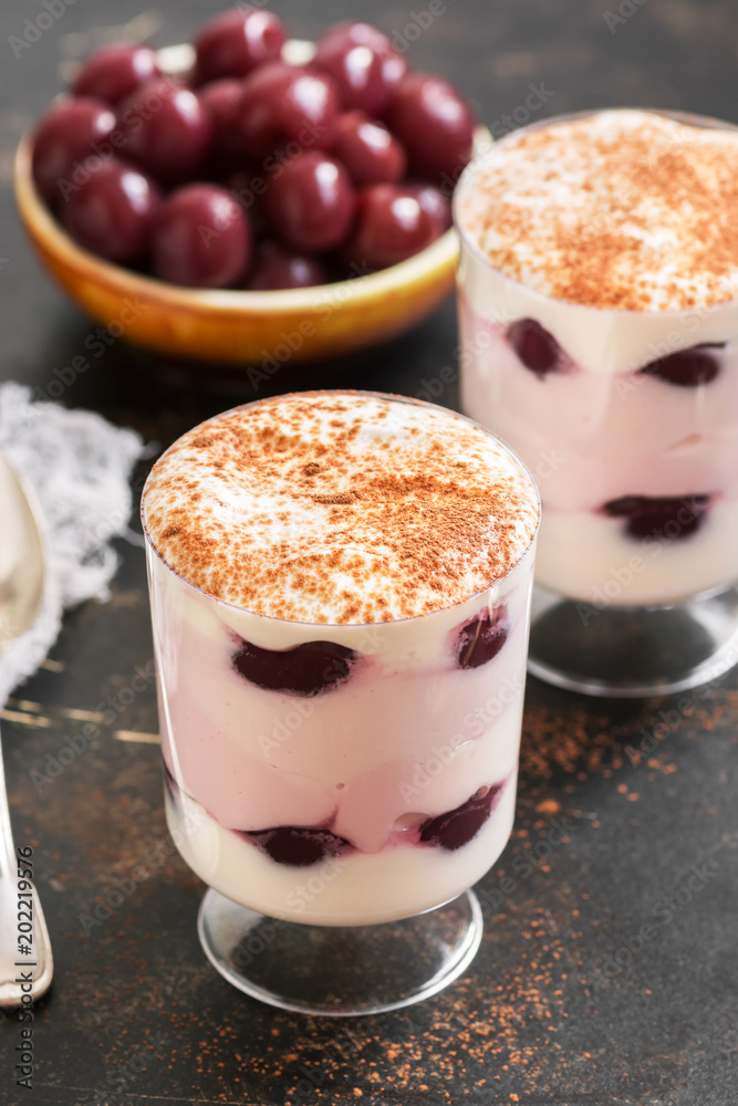 Dessert cream with cherries in glasses. White pink appetizing sweet dessert. Dessert cream with cherries in glasses. White pink appetizing sweet dessert.
