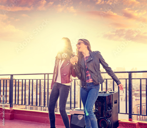 friends band firls singing karaoke at roof terrace photo