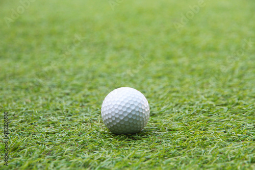 Golf ball in grass green 