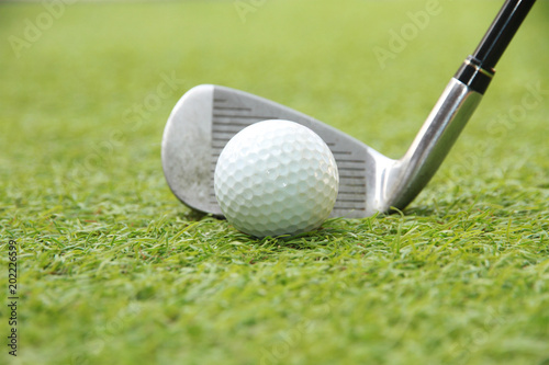 Golf ball and golf club in grass swing shot 