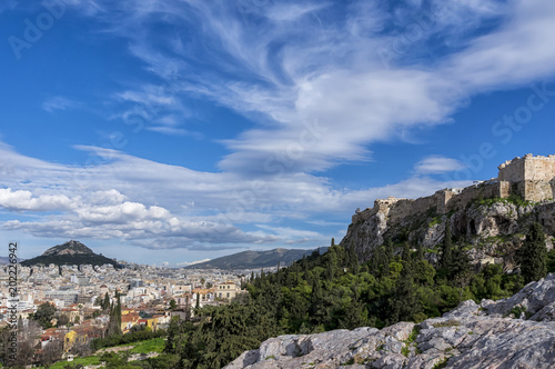 Athens, Greece. Panoramic view of the city of Athens, Acropolis, Lycabettus as seen from the vantage point of Areopagus hill in Plaka. Sunny day with blue cloudy sky