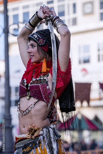 Woman dancing oriental dance on the street