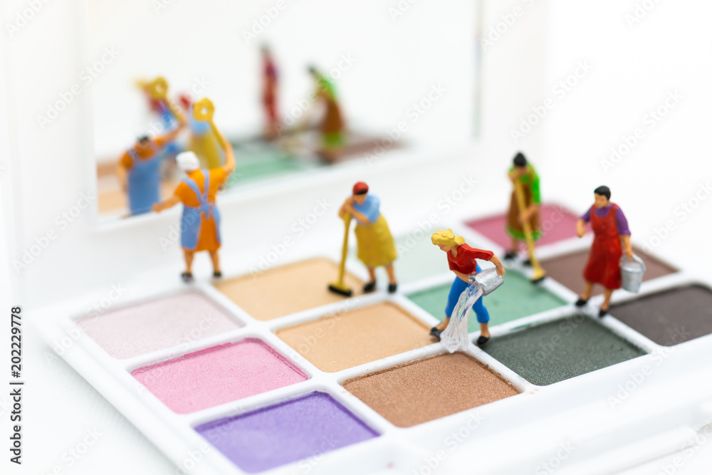 Miniature people: Women cleaning tools, eyeshadow. Image use for the beauty, cosmetic product.