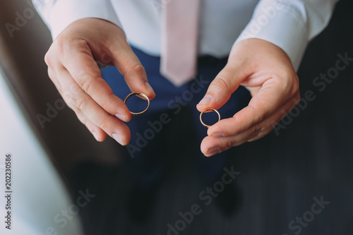 the bridegroom holds in the hands of wedding rings. preparation of the groom