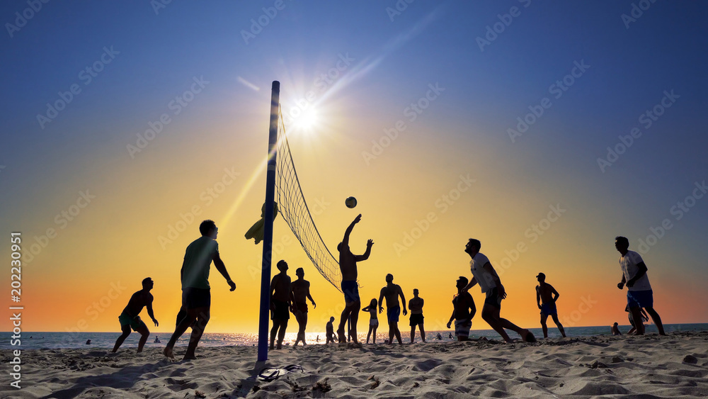 Durres, Albania - circa Aug, 2017: Unrecognizable people play Volleyball on the beach, at Sunset