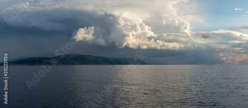 Sea landscape with stormy cloudy sky and Zakynthos island in background. Ionian Sea