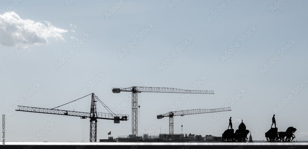 cranes and figures at the skyline of Madrid, spain cranes and figures at the skyline of Madrid, spain