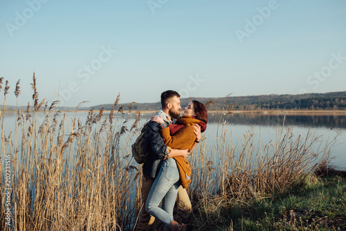 young loving couple on the lake near the reeds