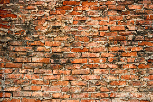 Background of cracked warehouse brick wall texture.