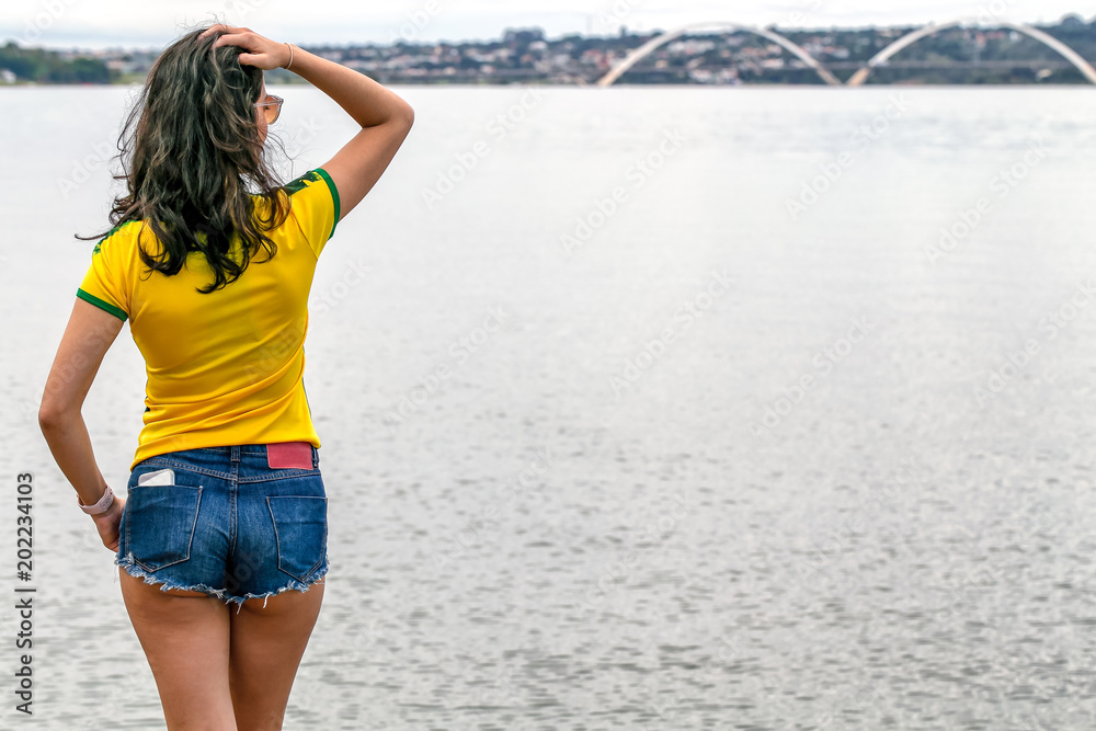 Walking on the lake. A beautiful brunette strolls in the afternoon in the lake of her city. Rest day. Relax. Summer sun. Healthy life. Modern life. Female beauty. Brasilia. Walking on the lake. A beautiful brunette strolls in the afternoon in the lake of her city. Rest day. Relax. Summer sun. Healthy life. Modern life. Female beauty. Brasilia.