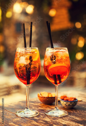 Two glasses of Aperol Spritz cocktails on the table in restaurant, Taormina, Sicily, Italy.