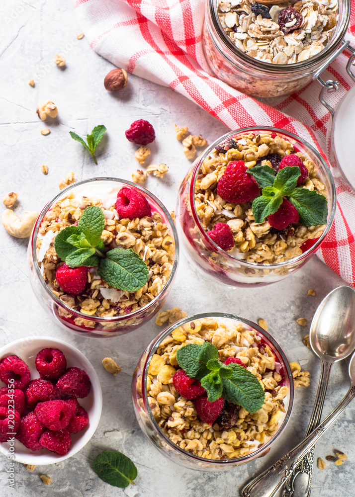 Yogurt parfafait with granola and raspberries top view.