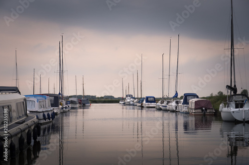 Pleasure boats moored at Thurne Great Yarmouth Norfolk England photo