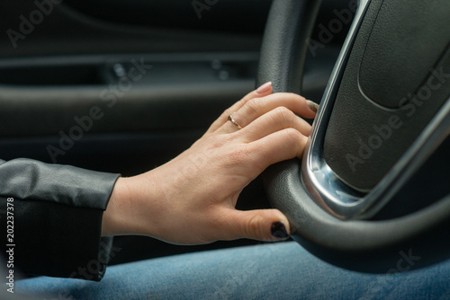 Women hands on the car's steering wheel. © ako-photography