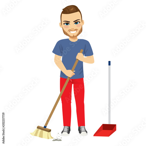 Young man sweeping home with broom doing household chores