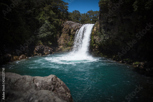 Fototapeta Naklejka Na Ścianę i Meble -  A waterfall flowing into a pool of water in New Zealand. 