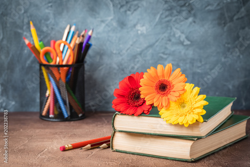 September 1 concept postcard, teachers day, back to school, supplies, alarm clock, daisies photo