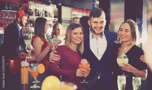 Man and two women at nightclub