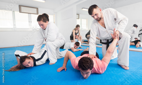Adults practicing new taekwondo holds