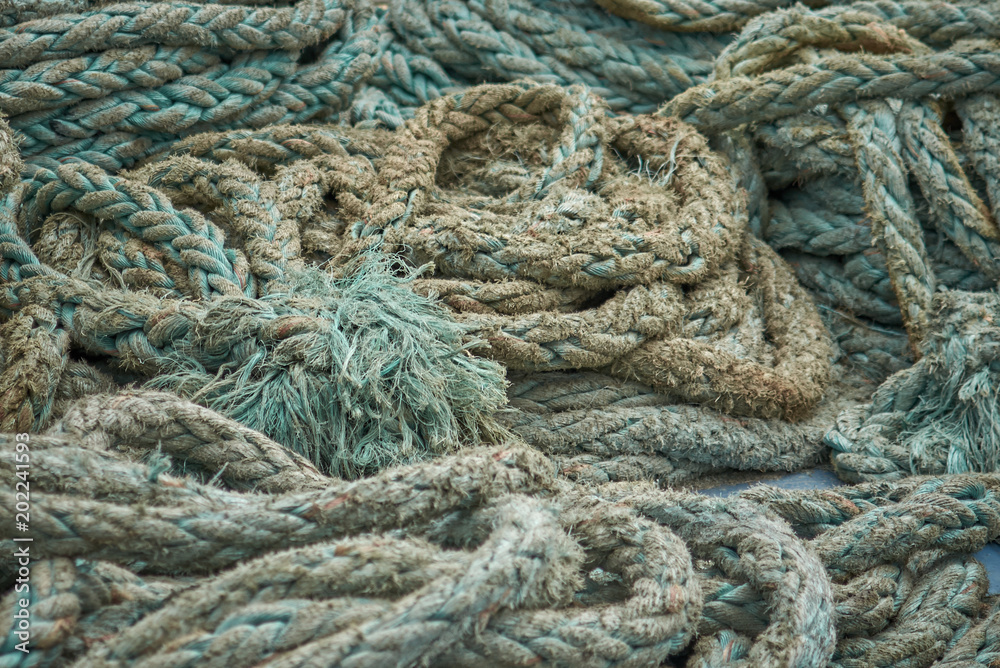 Ship’s mooring rough green ropes