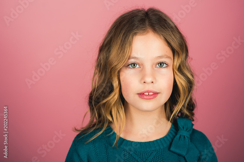 Hairdresser, skincare, casual style, denim. Little girl with long hair. Fashion model and beauty look. Stylish girl with pretty face on grey background. Beauty and kid fashion with healthy hair.