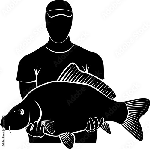 Silhouette of fisherman holding big carp fish