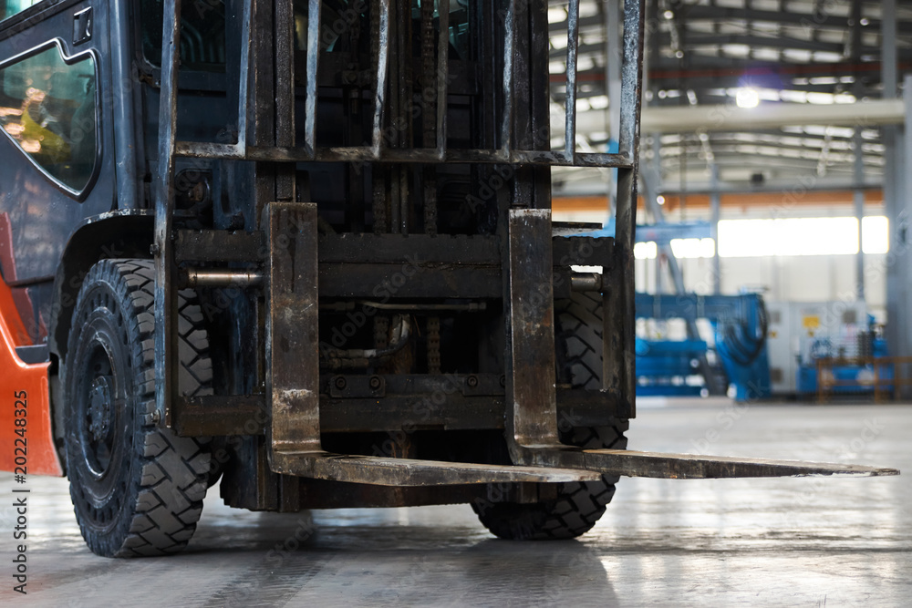 Working Forklift in warehouse. Forklift loader pallet stacker truck equipment at warehouse