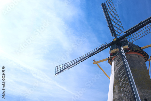 Old mill and blue sky in the netherlands. Free space for text. Card. Traveling in Europe