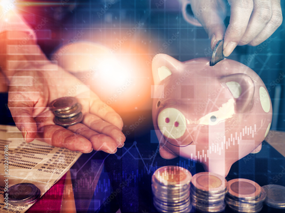 Saving money concept.Close up hand putting coin into piggy bank for ...