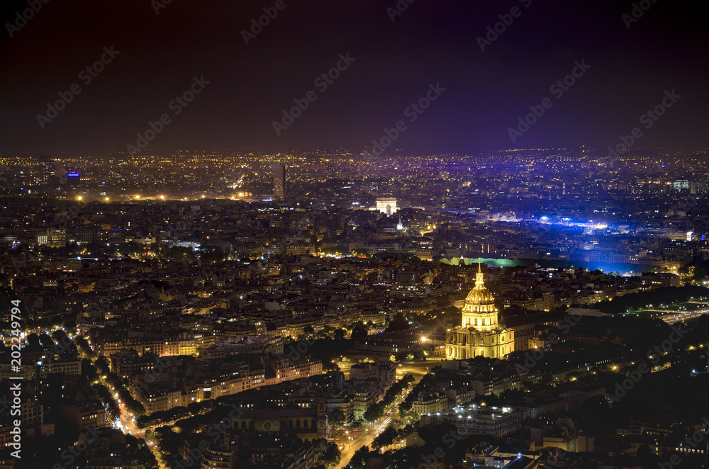 Aerial view of Paris city of light with veiw of  Domes Les Invalides and Arc de Triumph, at evening. View from Montparnasse highest skyscraper in France