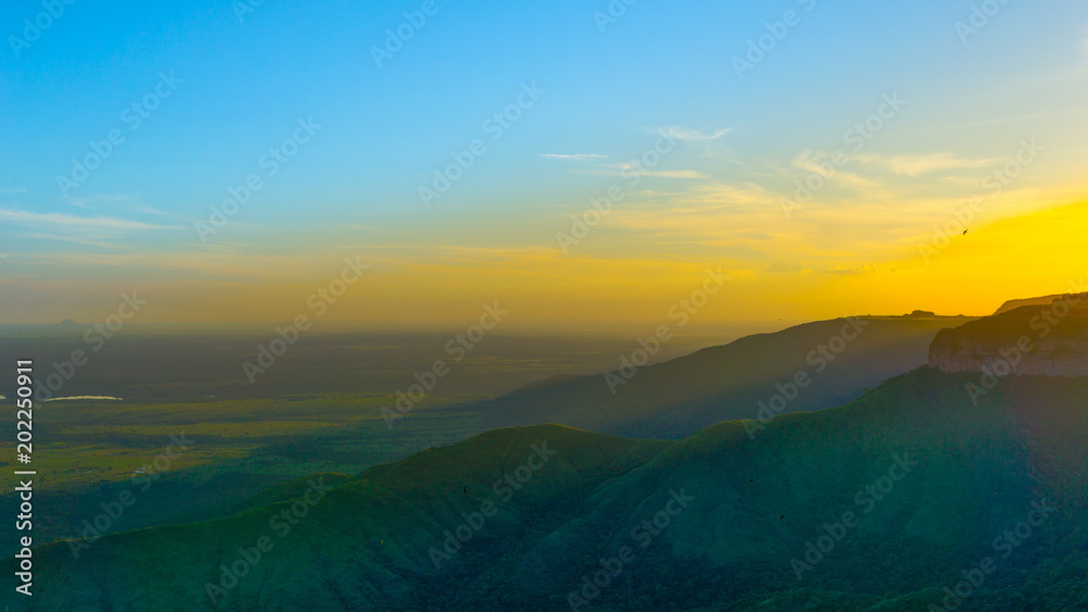 Sunrise on a cliff with a plain background