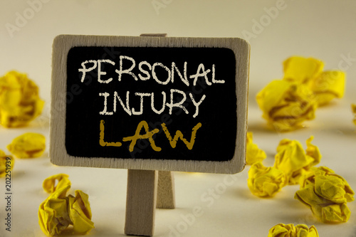 Text sign showing Personal Injury Law. Conceptual photo guarantee your rights in case of hazards or risks written on Wooden Notice Board on the plain background Yellow Paper Balls. photo