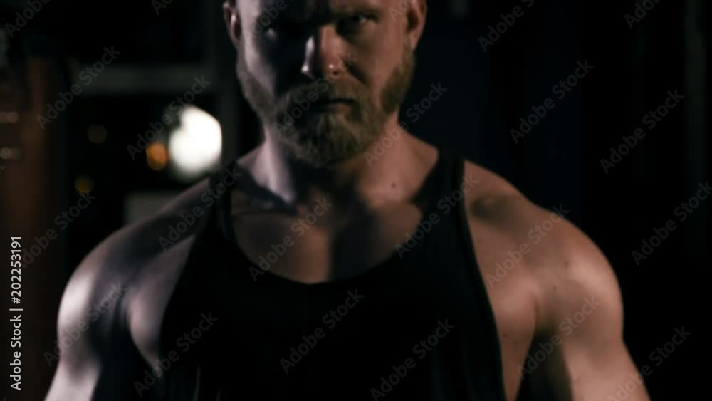 Strong man in training with a hammer and wheel Strong man in training with a hammer and wheel