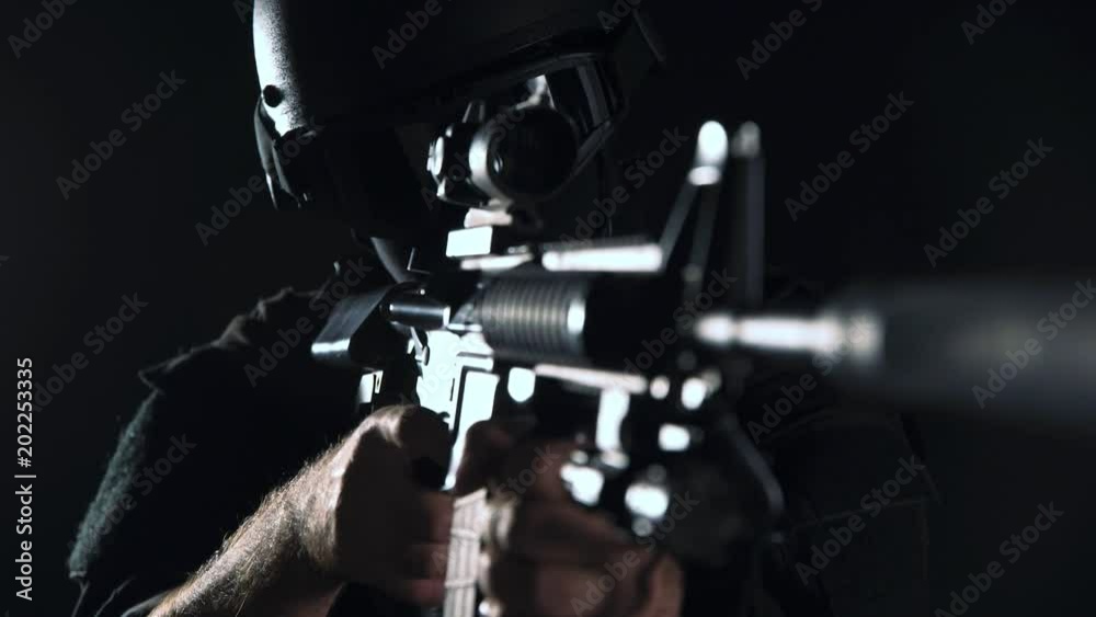 Spec ops police officer SWAT in black uniform studio Spec ops police officer SWAT in black uniform studio
