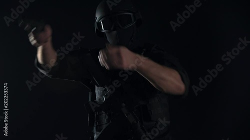 Spec ops police officer SWAT in black uniform studio